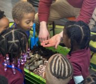 FoodPrints students checking out worms in compost STEM aligned food and garden education